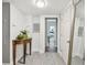 Inviting hallway with wood-look flooring, decorative table, and natural light at 859 Patterson Dr, Sarasota, FL 34234