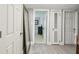 Hallway featuring tile floors, closet doors, and access to rooms at 859 Patterson Dr, Sarasota, FL 34234
