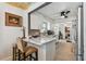Kitchen with marble countertops, white cabinets, stainless steel appliances and breakfast bar with stools at 859 Patterson Dr, Sarasota, FL 34234