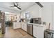 Kitchen features stainless steel appliances, white cabinets, granite countertops, and open to the dining area at 859 Patterson Dr, Sarasota, FL 34234