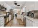 Bright kitchen featuring sleek, stainless steel appliances, marble countertops, and views into the dining area at 859 Patterson Dr, Sarasota, FL 34234