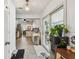 Open floor plan features kitchen with light wood flooring, chandelier and sliding doors at 859 Patterson Dr, Sarasota, FL 34234
