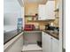 Kitchen with open cabinets, stainless steel sink, and dark countertops at 859 Patterson Dr, Sarasota, FL 34234