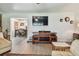 Bright living room shows view into dining area, entertainment center, hardwood floors and lots of natural light at 859 Patterson Dr, Sarasota, FL 34234
