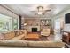 Living room featuring a fireplace, wood paneling, and ample seating at 859 Patterson Dr, Sarasota, FL 34234