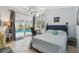 Bright bedroom featuring sliding glass doors with access to a beautiful pool, and a ceiling fan at 859 Patterson Dr, Sarasota, FL 34234