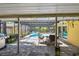 Covered patio with seating, a grill, and a view of the pool beyond at 859 Patterson Dr, Sarasota, FL 34234