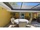 Outdoor patio featuring dining set, grill, and covered area for relaxed outdoor entertainment at 859 Patterson Dr, Sarasota, FL 34234