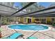 Enjoy this private backyard oasis with a sparkling pool, shaded pergola, and brick paver patio for ultimate relaxation at 859 Patterson Dr, Sarasota, FL 34234