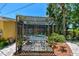 Screened in pool and deck area features lush foliage and outdoor dining, providing a relaxing oasis at 859 Patterson Dr, Sarasota, FL 34234