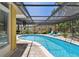 Inviting in-ground pool surrounded by brick patio and a screened enclosure for seamless indoor/outdoor living at 859 Patterson Dr, Sarasota, FL 34234