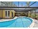 Relaxing in-ground pool with screened enclosure and a sunny patio space at 859 Patterson Dr, Sarasota, FL 34234