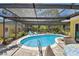 Stunning in-ground pool within a screened enclosure, featuring a patio and tranquil garden views at 859 Patterson Dr, Sarasota, FL 34234