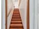 Wooden stairs lead to the upper level of the home at 859 Patterson Dr, Sarasota, FL 34234