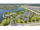 Aerial view of the neighborhood showing the community pool, tennis court, and waterfront homes at 9860 Smarty Jones Dr, Ruskin, FL 33573