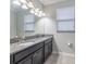 Bathroom with a granite vanity, mirror and modern vanity lighting at 9860 Smarty Jones Dr, Ruskin, FL 33573