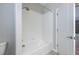 Bathroom with a shower/tub combination featuring white tiling from floor to ceiling at 9860 Smarty Jones Dr, Ruskin, FL 33573