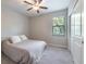 A cozy bedroom featuring a ceiling fan, neutral walls, and a comfortable bed with plush pillows at 9860 Smarty Jones Dr, Ruskin, FL 33573