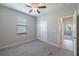 Bedroom with a ceiling fan and natural light, with access to another room at 9860 Smarty Jones Dr, Ruskin, FL 33573