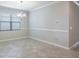 Clean and spacious dining room featuring tile flooring, elegant trim, and a modern chandelier, great for entertaining at 9860 Smarty Jones Dr, Ruskin, FL 33573