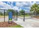 Fenced community dog park featuring shade trees, seating, and a welcoming entrance sign at 9860 Smarty Jones Dr, Ruskin, FL 33573