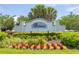 Welcoming entrance to Belmont community, adorned with colorful flowers and lush landscaping at 9860 Smarty Jones Dr, Ruskin, FL 33573