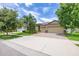 Charming single-Gathering home featuring a manicured lawn, mature trees, and a two-car garage with brick-paved driveway at 9860 Smarty Jones Dr, Ruskin, FL 33573