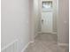 Bright foyer featuring neutral paint, tile flooring, and a contemporary front door with transom window at 9860 Smarty Jones Dr, Ruskin, FL 33573