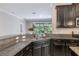 Kitchen showcasing granite counters, stainless steel appliances, and a view to the exterior at 9860 Smarty Jones Dr, Ruskin, FL 33573