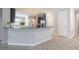 Bright kitchen featuring granite countertops, tiled floors, and stainless steel appliances at 9860 Smarty Jones Dr, Ruskin, FL 33573