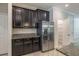 The kitchen features granite countertops, stainless steel refrigerator, and white molding at 9860 Smarty Jones Dr, Ruskin, FL 33573