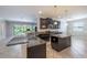 Spacious kitchen featuring granite countertops and a central island, perfect for entertaining at 9860 Smarty Jones Dr, Ruskin, FL 33573