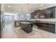 An open-concept kitchen featuring stainless steel appliances and an eat-in island at 9860 Smarty Jones Dr, Ruskin, FL 33573