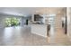 Open-concept kitchen with modern appliances, granite countertops, and a seamless flow into the living area at 9860 Smarty Jones Dr, Ruskin, FL 33573