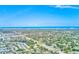 Expansive aerial view showcasing a vibrant community with the ocean in the distance at 11082 90Th Ter, Seminole, FL 33772
