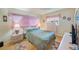 Cozy bedroom featuring a ceiling fan, natural light, and a comfortable bed at 11082 90Th Ter, Seminole, FL 33772