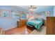 Comfortable bedroom with natural light, hardwood floors, and wood furniture at 11082 90Th Ter, Seminole, FL 33772