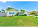 Charming single-story home with a lush front lawn, manicured hedges, and an American flag at 11082 90Th Ter, Seminole, FL 33772