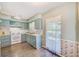 Charming kitchen features blue cabinetry, white appliances, and ample natural light at 11082 90Th Ter, Seminole, FL 33772