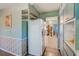 Open kitchen with shelving, white refrigerator and a view to the dining area at 11082 90Th Ter, Seminole, FL 33772