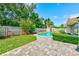 Backyard showcasing a private pool with well-maintained landscaping and a paved patio area at 11082 90Th Ter, Seminole, FL 33772