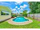 Backyard showcasing a private pool with well-maintained landscaping and a paved patio area at 11082 90Th Ter, Seminole, FL 33772