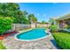 Inviting backyard pool and patio area with tropical landscaping at 11082 90Th Ter, Seminole, FL 33772