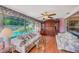 Cozy sunroom with large windows offering views of the pool and outdoor area at 11082 90Th Ter, Seminole, FL 33772