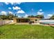 Well maintained backyard with lawn, above ground pool, and enclosed patio at 11398 88Th Ave, Seminole, FL 33772