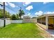 Lush backyard featuring an enclosed patio and white fencing at 11398 88Th Ave, Seminole, FL 33772