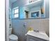 Tiled bathroom with white fixtures, large mirror and essential amenities at 11398 88Th Ave, Seminole, FL 33772