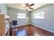 Bright bedroom with hardwood floors, modern ceiling fan and two windows at 11398 88Th Ave, Seminole, FL 33772