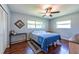 Well-lit bedroom with wood-look floors and a ceiling fan at 11398 88Th Ave, Seminole, FL 33772