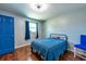 Cozy bedroom featuring hardwood floors, a comfy bed and bright blue door at 11398 88Th Ave, Seminole, FL 33772